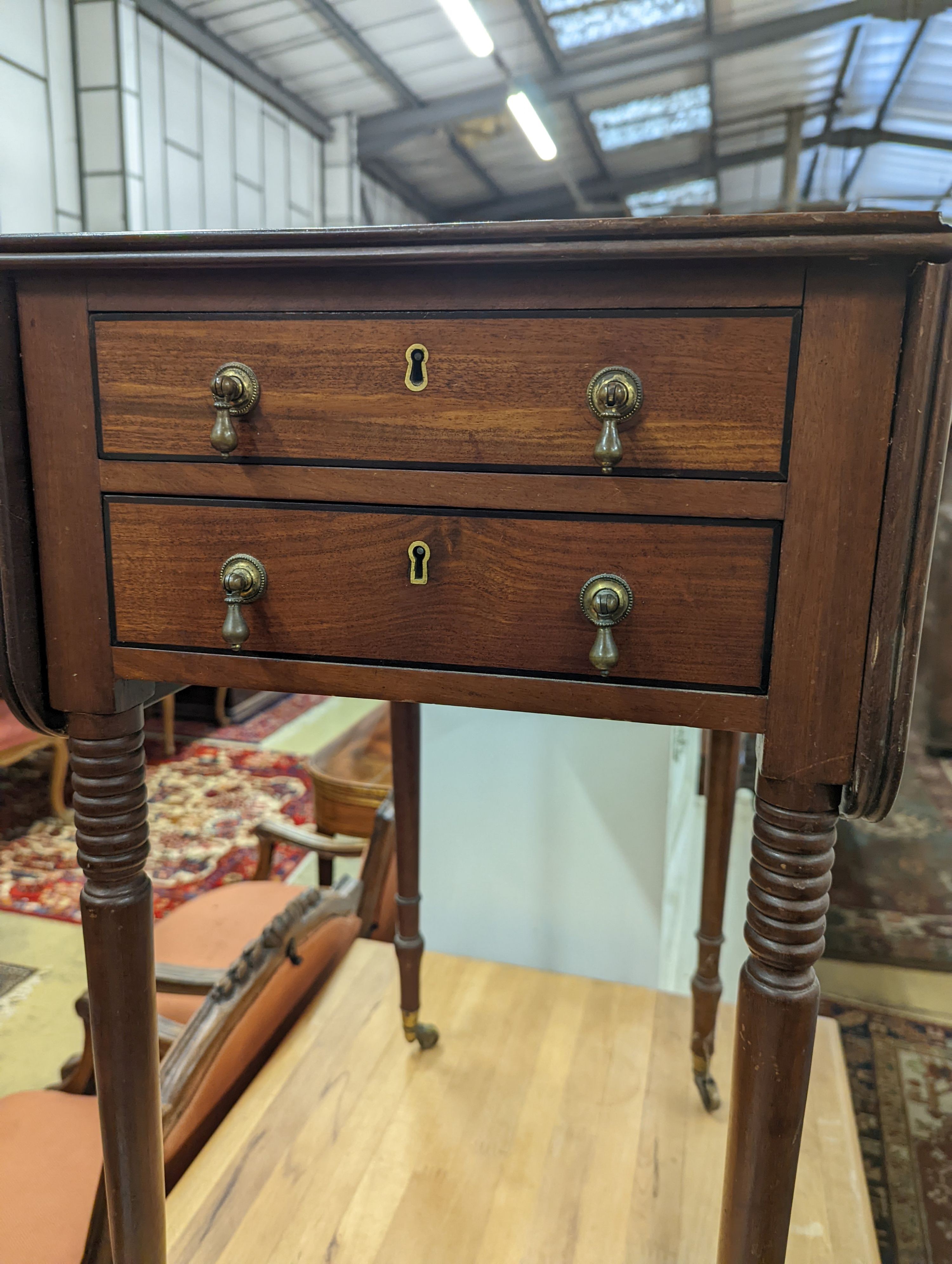 A Regency mahogany drop flap work table, the drawers with brass pear drop handles, width 37cm, depth 53cm, height 73cm